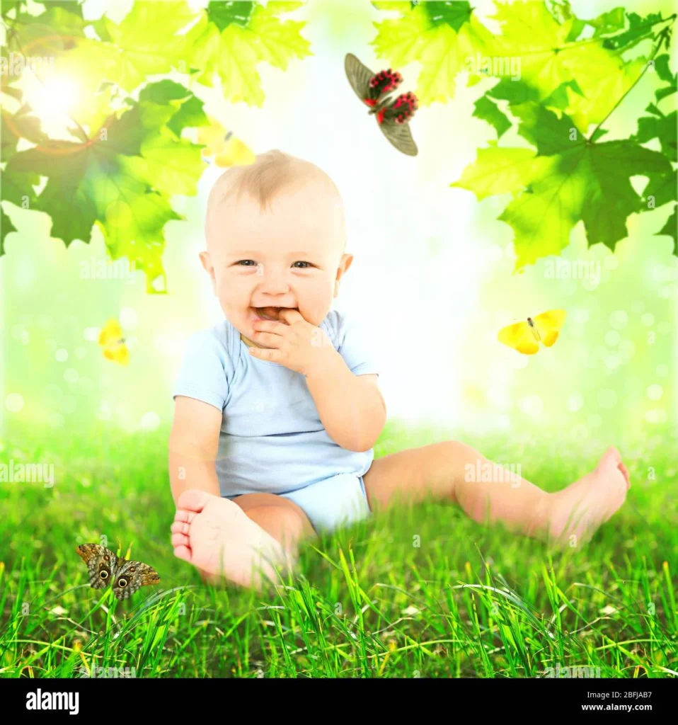 smiling baby sitting on grass surrounded by butterflies and green leaves in a bright, natural setting